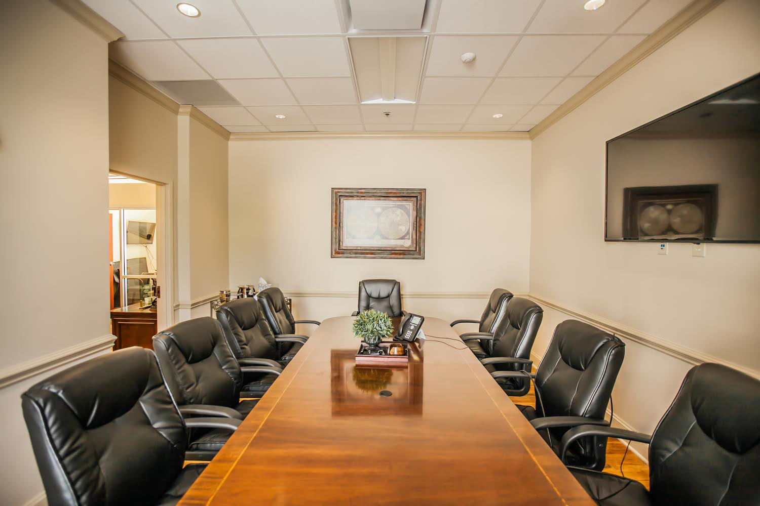 A long table with nine ergonomic chairs